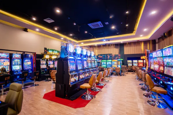 A glamorous woman holding casino chips in a neon-lit environment, representing the premium online casino atmosphere of 2J777.