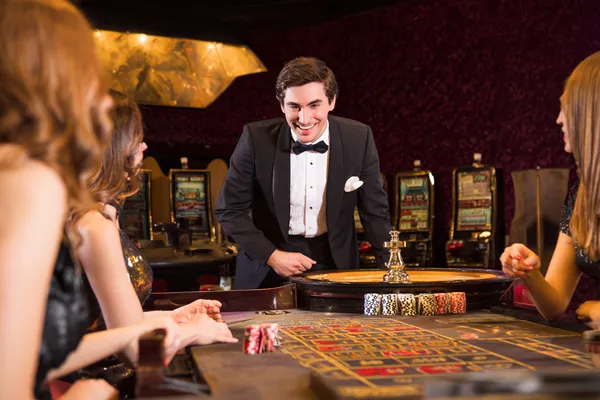 A stylish woman beside vibrant slot machines displaying glowing sevens, showcasing the variety of top slots at 2J777.