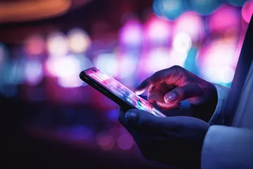 A woman smiling by bright slot machines showing lucky symbols, showcasing the exciting slot offerings at 2J777.
